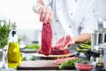 Chef cutting and cooking meat in the restaurant kitchen Royalty Free Stock Photo
