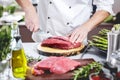 Chef cutting and cooking meat in the restaurant kitchen Royalty Free Stock Photo