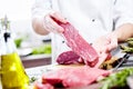 Chef cutting and cooking meat in the restaurant kitchen Royalty Free Stock Photo