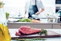 Chef in restaurant kitchen cooking,he is cutting meat or steak Royalty Free Stock Photo