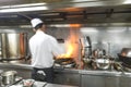 Chef in restaurant kitchen at stove with pan Royalty Free Stock Photo