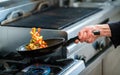 Chef is roasting vegetables in pan Royalty Free Stock Photo