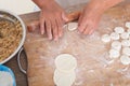 The chef is rolling out dumpling skins to make dumplings