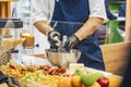 Chef& x27;s gloved hands grating piece of cheese with steel grater in professional kitchen. Cooking pasta, pizza, lasagna Royalty Free Stock Photo