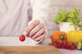 Chef`s hands. Man is ready to prepare fresh salad.