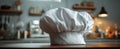 The Chef's Hat Ready for Culinary Adventures in a Cozy Kitchen.AI generated image Royalty Free Stock Photo