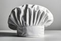ChefÆ??s toque with pleats, resting on flat surface, plain background Royalty Free Stock Photo
