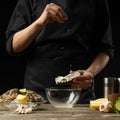 Chef salting oyster with lemon on the background of dry wine on a dark background, menu, restaurant, Italian cuisine, Restaurant