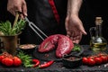 Chef salts tenderloin fillet in a freeze motion with rosemary and spices. Preparing fresh beef steak ready to cook, long banner Royalty Free Stock Photo