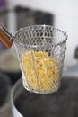 Chef scald raw egg noodles in traditional steel wire mesh Royalty Free Stock Photo