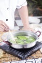 Chef scald vegetable in pot before cooking noodle