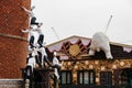 Chef sculptures connect with the others to lean the sloped building and climbing white bear at Shiroi Koibito Park in Sapporo.