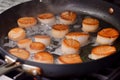 chef searing scallops in a nonstick pan