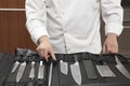 Chef Selecting Knife Sharpener Out Of Full Set