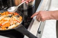 Chef selects the operating mode of the electric stove with a touch button. For cooking vegetable frying for soup