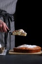 Chef serves the pie on dark background. pie recipe concept
