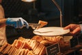 Chef is serving canapes toasted bread with cheese and tomato in a restaurant.