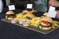 Chef serving different types of hamburgs with sausage Royalty Free Stock Photo