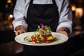 Chef serving a dish with artistic presentation, adorned with flowers and sauce Royalty Free Stock Photo