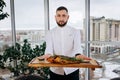 Chef serving freshly delicious river carp fish in the restaurant hall