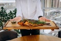 Chef serving freshly delicious river carp fish in the restaurant hall