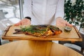 Chef serving freshly delicious river carp fish in the restaurant hall