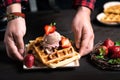 Chef serving freshly made waffle dessert Royalty Free Stock Photo