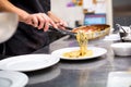 Chef serving Italian pasta in a restaurant kitchen