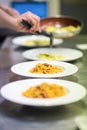 Chef serving or plating up pasta in a restaurant