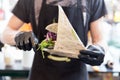 Chef serving organic vegetarian fish burger at international urban street food festival.