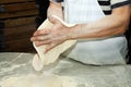 Chef shaping pizza dough