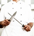 Chef Sharpening Kitchen Knife at Work Royalty Free Stock Photo