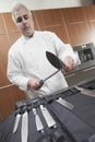 Chef Sharpening Knives In Commercial Kitchen