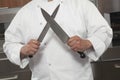 Chef Sharpening Knives In Commercial Kitchen