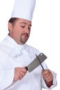 Chef sharpening meat cleaver