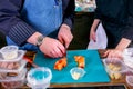 Chef showing student how to cut a tomato. Master class in the kitchen. The process of cooking. Step by step. Tutorial. Close-up