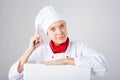 Chef Sign. Woman cook looking over paper sign billboard. Surprised and funny expression woman isolated on white background Royalty Free Stock Photo