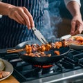 Chef skillfully grills flavorful barbecue skewers on a smoky stove top