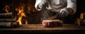 The chef skillfully seasons a thick cut of meat in a rustic kitchen. AI generated image Royalty Free Stock Photo