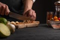 Chef slices fresh garlic to make fresh salad and Italian pasta. Culinary recipes, cookbooks, homemade recipes