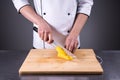 Chef slices and peels ripe mango in the restaurant kitchen1