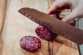 Chef slices salami on a wooden board Royalty Free Stock Photo