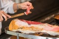 Chef slices serrano ham. Jamon Serrano. Typical Spanish delicate Royalty Free Stock Photo
