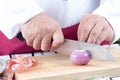 Chef slices shallots