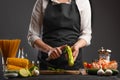 Chef slices zucchini for cooking shrimp, seafood, healthy and delicious Asian oriental cuisine Royalty Free Stock Photo