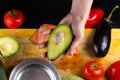 Chef slicing the avocado closeup on a wooden board