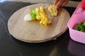 Chef is slicing bell pepper and pineapple fruit with a knife Royalty Free Stock Photo