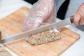 Chef slicing bread in the kitchen ,knife