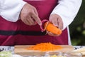 Chef slicing carrots with peeler Royalty Free Stock Photo