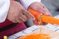 Chef slicing carrots with peeler Royalty Free Stock Photo